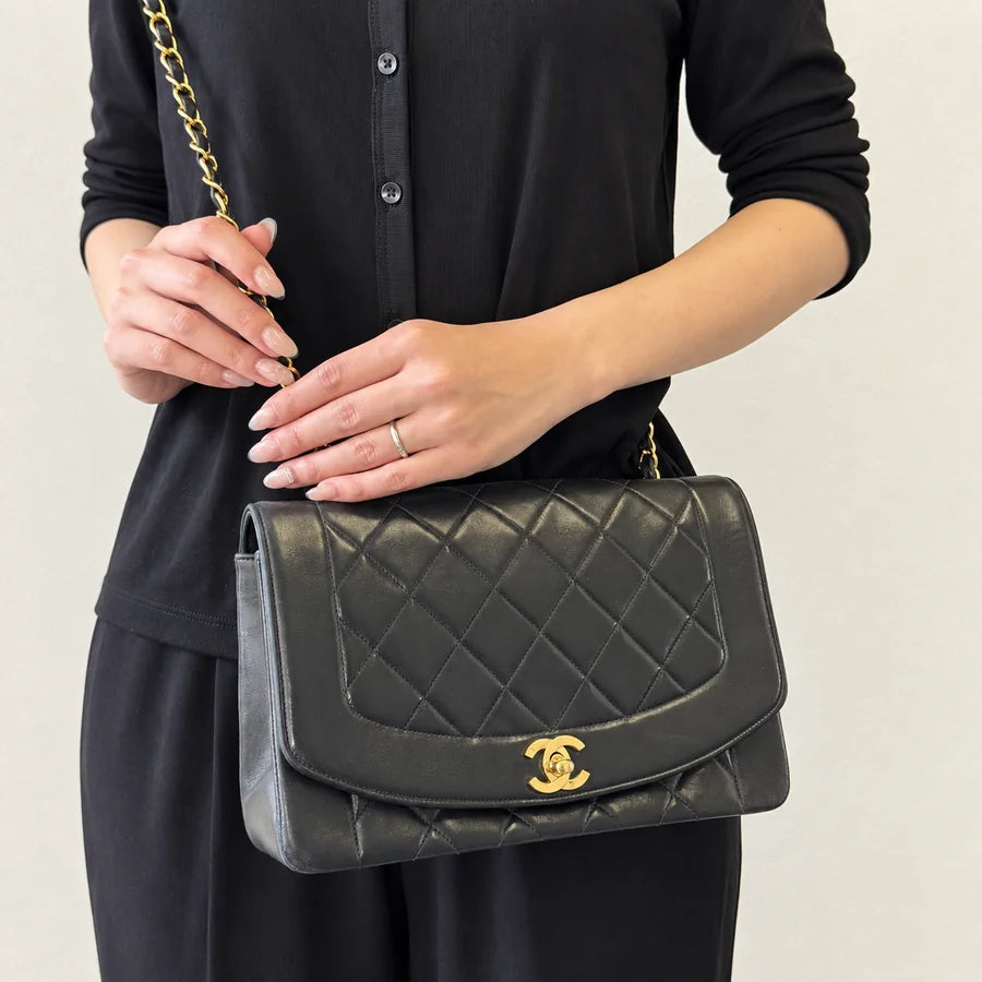 Chain bag worn with black clothing
