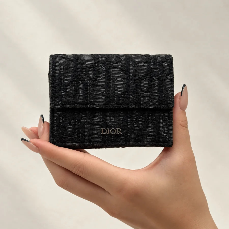 Black wallet held in both hands